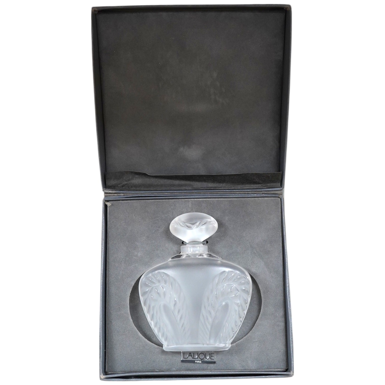 A Lalique ‘Singapore’ pattern frosted glass scent bottle and stopper in associated Lalique box, bottle 10cm. Condition - good